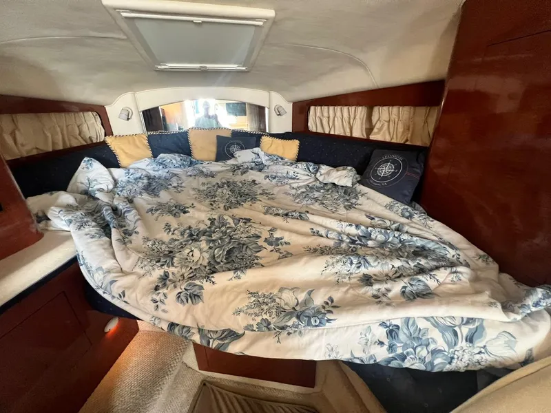 Slide: The Image of Cozy cabin interior of 2003 Sea Ray 300 Sundancer with floral bedding. - 20