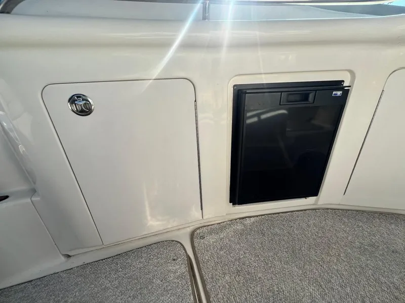 Slide: The Image of 2003 Sea Ray 300 Sundancer interior with cabinet and mini fridge. - 6