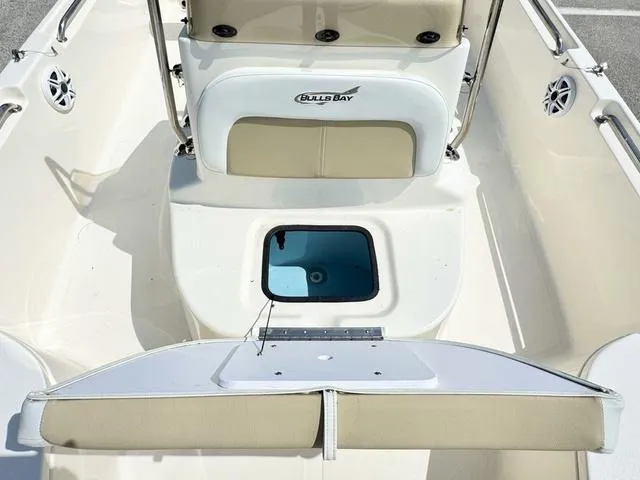 Slide: The Image of 2024 Bulls Bay 2000 boat interior with seating and storage compartments. - 13