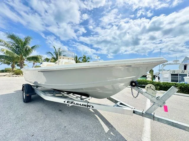 Slide: The Image of 2024 Bulls Bay 2000 boat on trailer under a partly cloudy sky. - 16