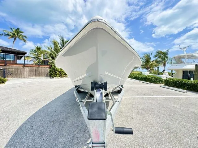 Slide: The Image of 2024 Bulls Bay 2000 boat on trailer, parked under a clear blue sky. - 17