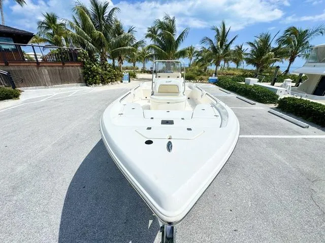 Slide: The Image of 2024 Bulls Bay 2000 boat parked near palm trees under a clear sky. - 18