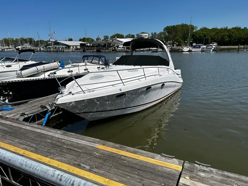The Image of 2007 Four Winns 318 Vista boat docked in a marina on a sunny day. - 0