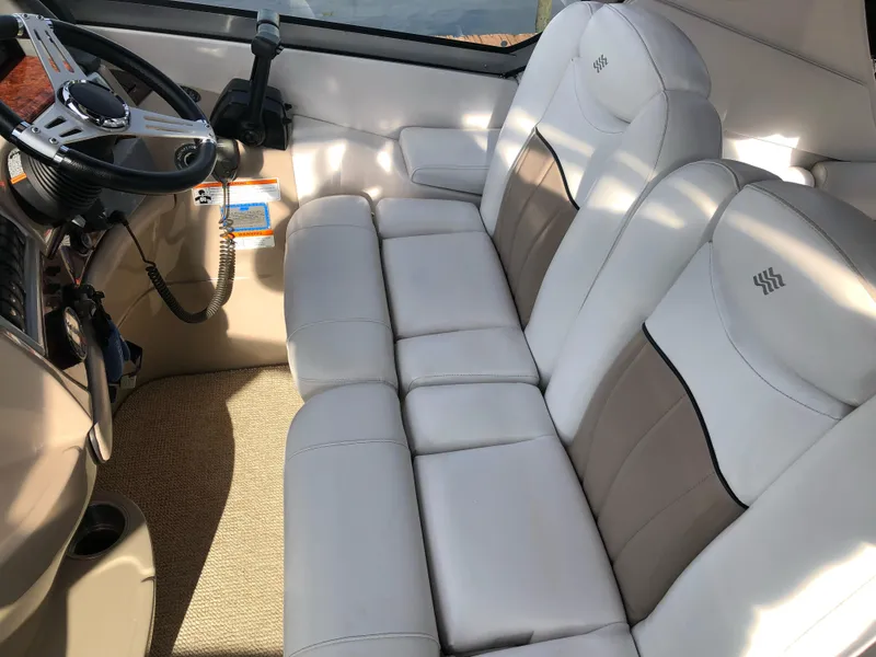 Slide: The Image of 2007 Four Winns 318 Vista boat interior with white leather seating and steering wheel. - 10