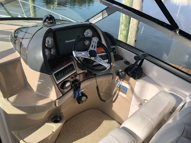 Slide: The Image of 2007 Four Winns 318 Vista boat cockpit with steering wheel and control panel. - 13