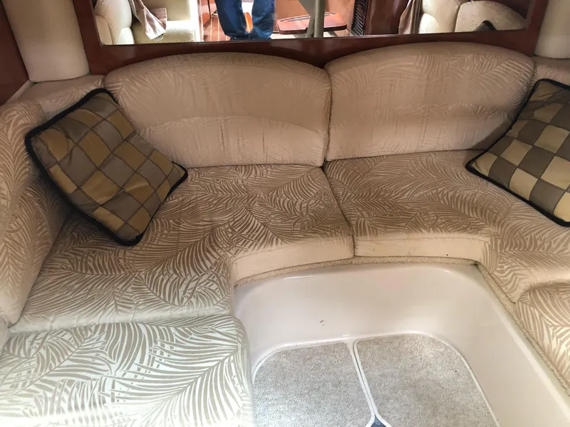 Slide: The Image of 2007 Four Winns 318 Vista cabin interior with patterned seating and checkered cushions. - 20