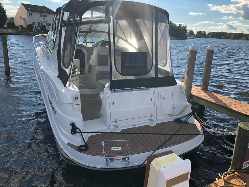 Slide: The Image of 2007 Four Winns 318 Vista boat docked by the water on a sunny day. - 22