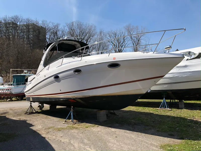 Slide: The Image of 2007 Four Winns 318 Vista boat on stands, outdoors, under clear blue sky. - 3