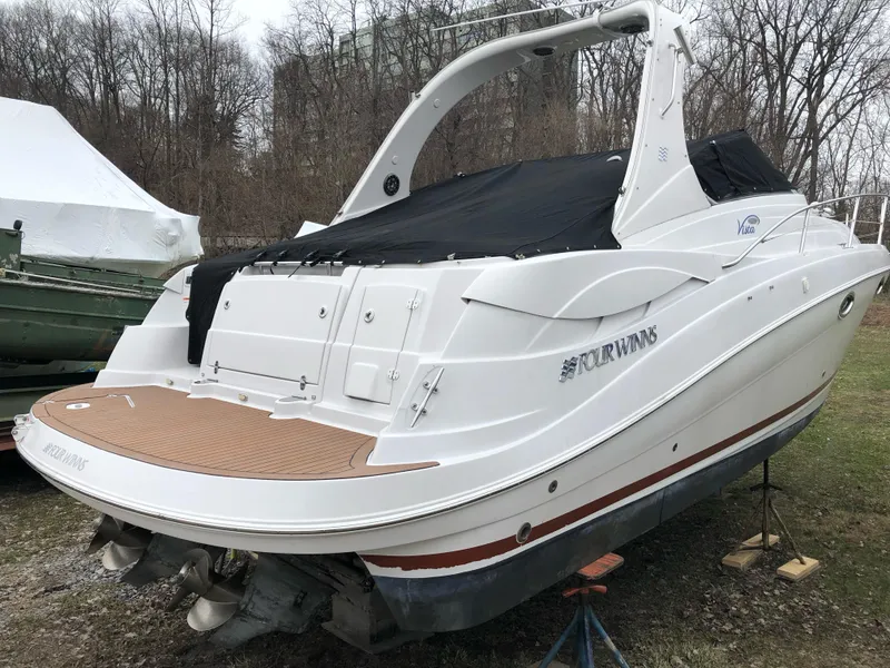 Slide: The Image of 2007 Four Winns 318 Vista boat with covered deck, parked on land. - 8