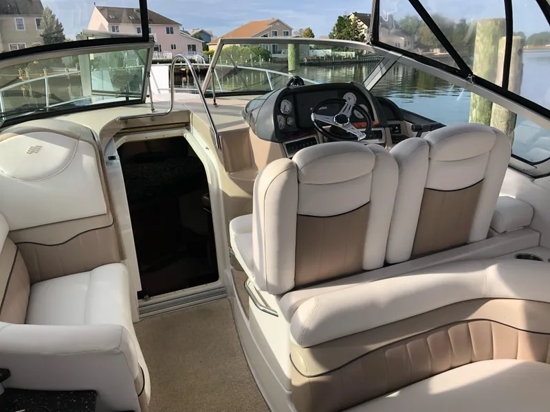 Slide: The Image of 2007 Four Winns 318 Vista boat interior with beige seating and steering console. - 9