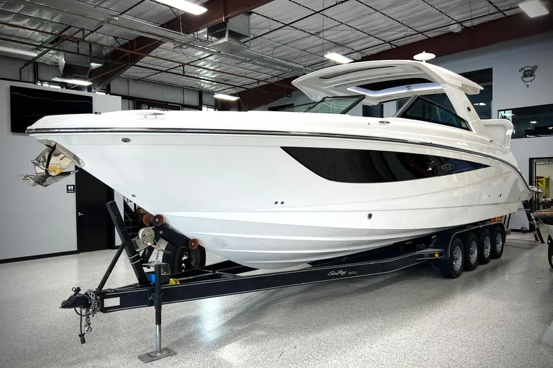Slide: The Image of 2024 Sea Ray SLX 400 boat on trailer in showroom, side view. - 0