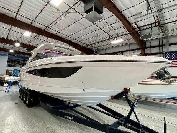 Slide: The Image of 2024 Sea Ray SLX 400 boat in indoor showroom on trailer. - 1