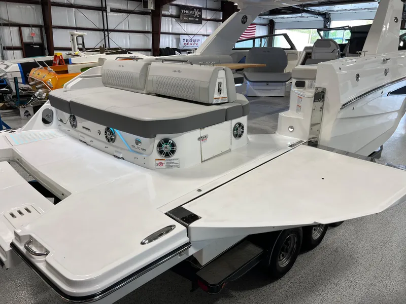 Slide: The Image of 2024 Sea Ray SLX 400 boat with spacious deck and seating in showroom. - 10