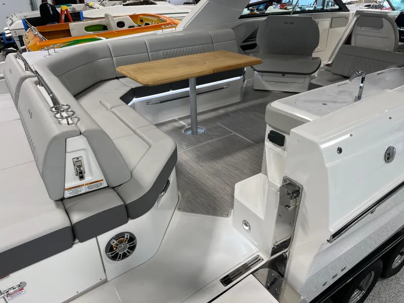 Slide: The Image of 2024 Sea Ray SLX 400 boat interior with luxurious seating and wooden table. - 11