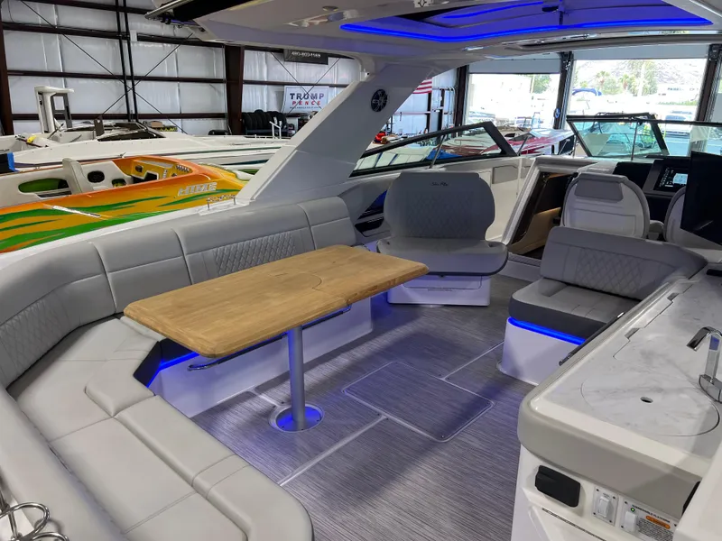 Slide: The Image of 2024 Sea Ray SLX 400 boat interior with modern seating and ambient lighting. - 12