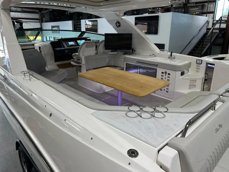 Slide: The Image of 2024 Sea Ray SLX 400 luxury boat interior with seating, table, and modern amenities. - 13
