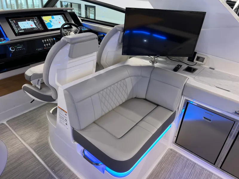 Slide: The Image of 2024 Sea Ray SLX 400 interior with plush seating, modern helm, and entertainment system. - 14