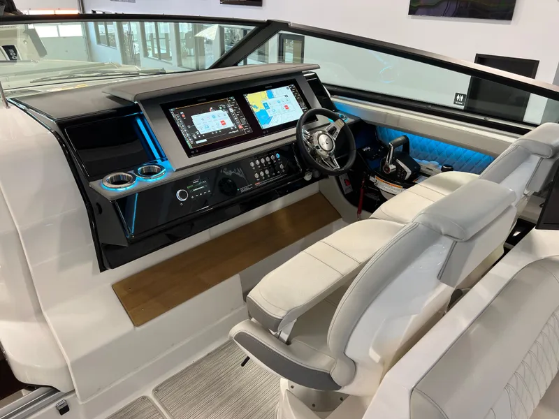 Slide: The Image of 2024 Sea Ray SLX 400 helm with modern controls and dual seating. - 16