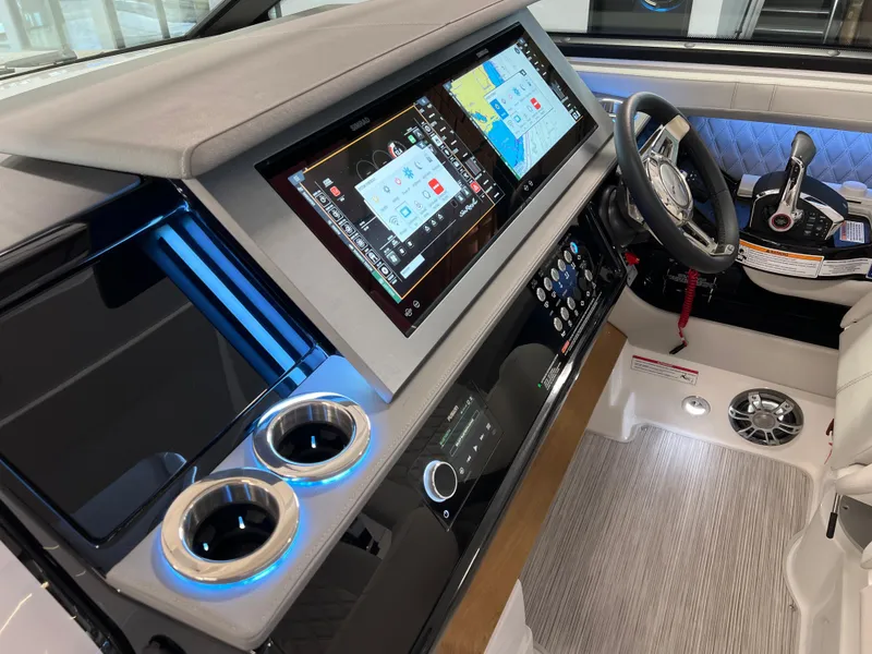 Slide: The Image of 2024 Sea Ray SLX 400 helm with dual displays and modern controls. - 17
