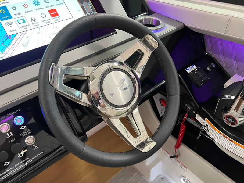 Slide: The Image of 2024 Sea Ray SLX 400 steering wheel and dashboard with modern controls. - 18