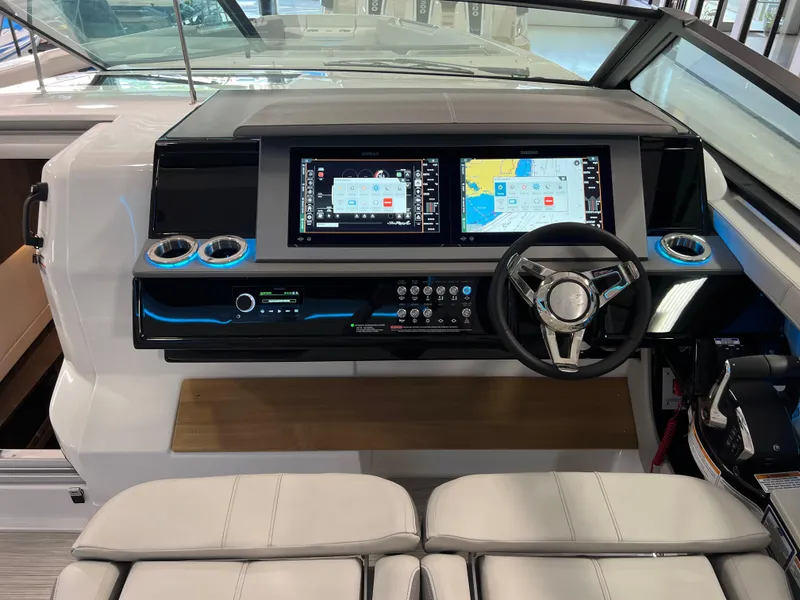 Slide: The Image of 2024 Sea Ray SLX 400 helm with dual displays and modern steering wheel. - 19