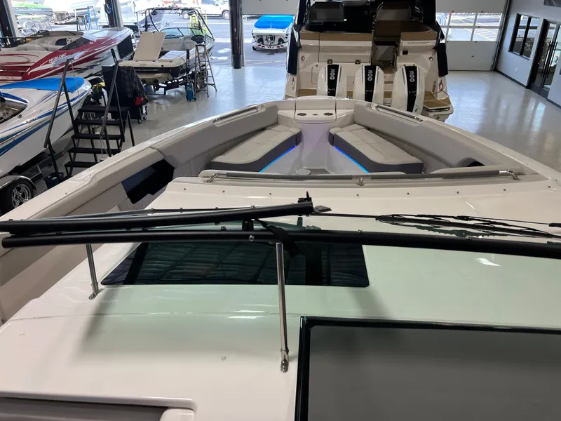 Slide: The Image of 2024 Sea Ray SLX 400 boat interior with seating and windshield in showroom. - 20