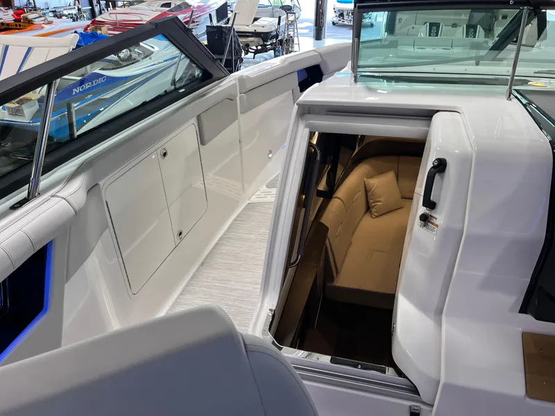 Slide: The Image of 2024 Sea Ray SLX 400 boat interior with cabin entrance and seating area. - 21