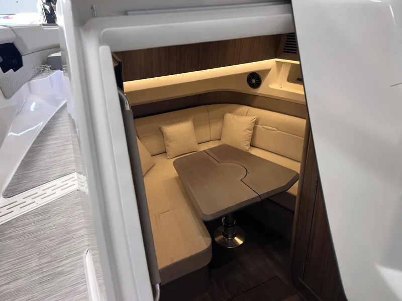 Slide: The Image of 2024 Sea Ray SLX 400 cabin interior with cozy seating and table. - 22
