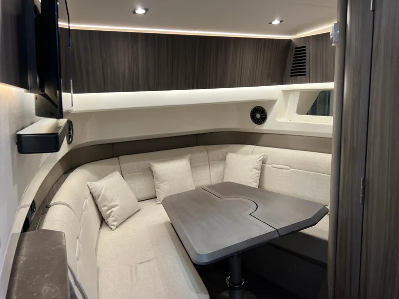 Slide: The Image of 2024 Sea Ray SLX 400 cabin interior with modern seating and table. - 23