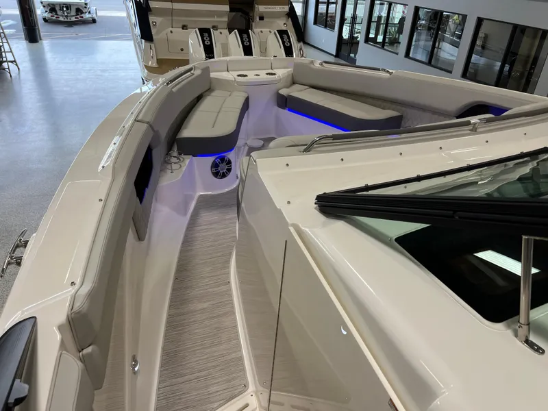 Slide: The Image of 2024 Sea Ray SLX 400 boat interior with modern seating and ambient lighting. - 29