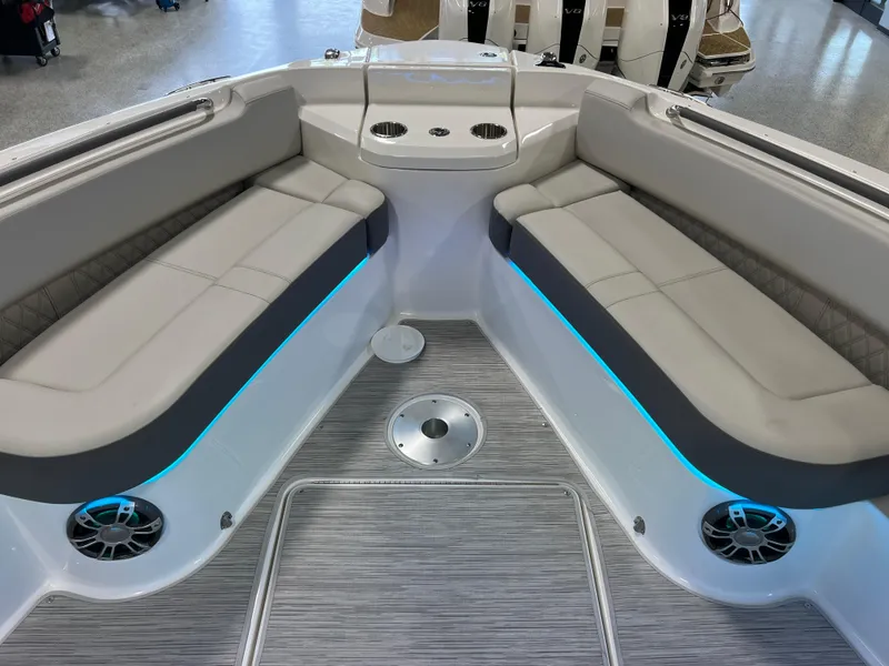 Slide: The Image of 2024 Sea Ray SLX 400 boat interior with cushioned seating and ambient lighting. - 32