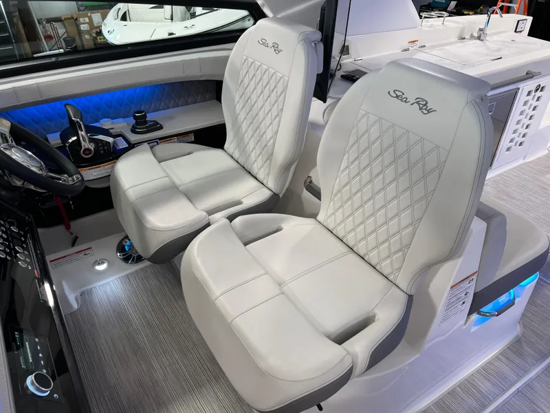 Slide: The Image of 2024 Sea Ray SLX 400 interior with luxurious white seating and modern dashboard. - 45