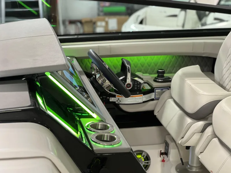 Slide: The Image of 2024 Sea Ray SLX 400 helm with modern controls and green ambient lighting. - 47