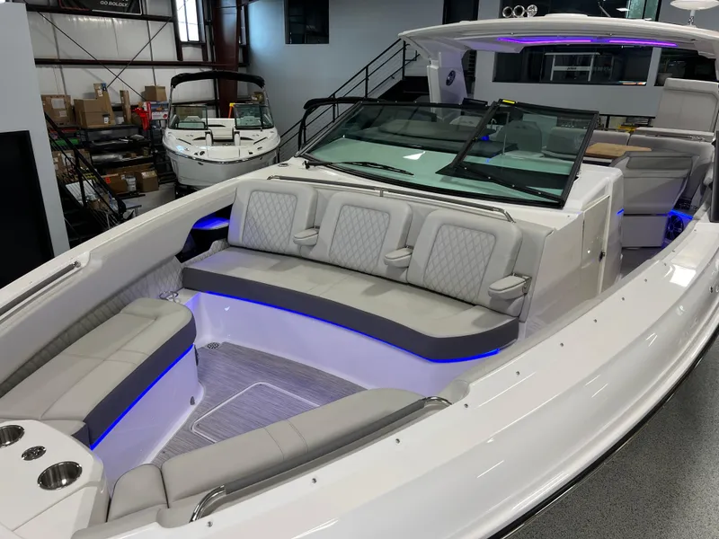 Slide: The Image of 2024 Sea Ray SLX 400 luxury boat interior with plush seating and ambient lighting. - 5