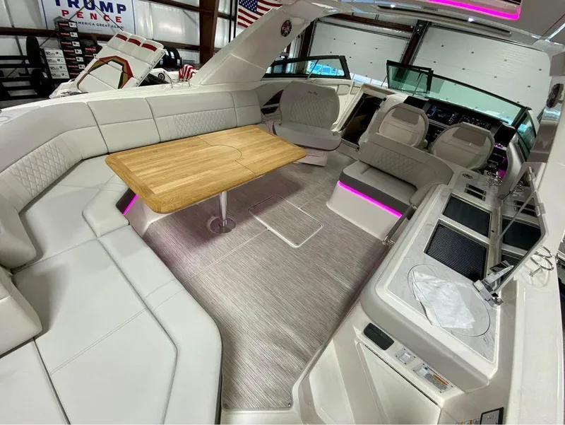 Slide: The Image of 2024 Sea Ray SLX 400 interior with modern seating and wooden table. - 67