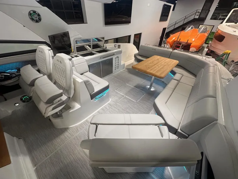 Slide: The Image of 2024 Sea Ray SLX 400 boat interior with seating and table. - 68
