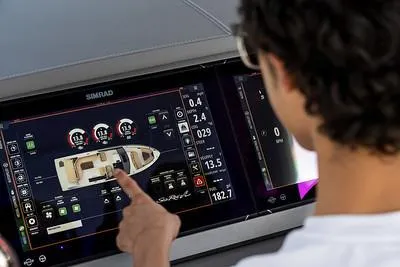 Slide: The Image of Person using touchscreen control panel on 2024 Sea Ray SLX 400 boat. - 72