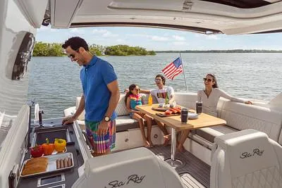 Slide: The Image of Family enjoying a day on a 2024 Sea Ray SLX 400 boat. - 73