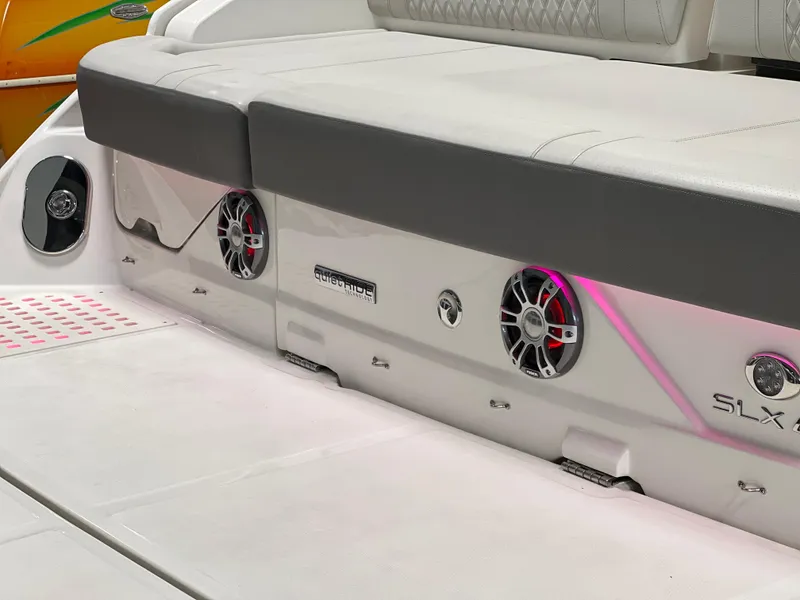 Slide: The Image of 2024 Sea Ray SLX 400 boat seating area with integrated speakers and modern design. - 8