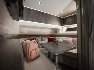 Slide: The Image of Interior cabin of 2024 Sea Ray SLX 400 with modern decor and seating area. - 82