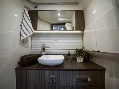 Slide: The Image of Modern bathroom in 2024 Sea Ray SLX 400 yacht with sleek vanity and vessel sink. - 85