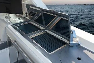 Slide: The Image of 2024 Sea Ray SLX 400 boat with open grill and ocean view. - 88