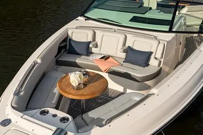 Slide: The Image of Luxurious seating area on the 2024 Sea Ray SLX 400 boat with a wooden table. - 91