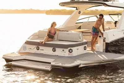 Slide: The Image of 2024 Sea Ray SLX 400 luxury boat with people relaxing on the deck at sunset. - 92