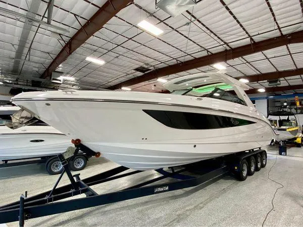 Slide: The Image of 2024 Sea Ray SLX 400 boat on trailer in indoor showroom. - 95