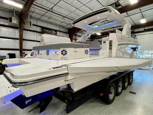Slide: The Image of 2024 Sea Ray SLX 400 luxury boat in a showroom on a trailer. - 96