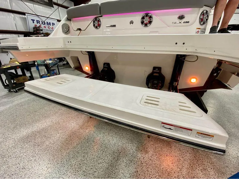 Slide: The Image of 2024 Sea Ray SLX 400 boat rear view with swim platform in a garage. - 97