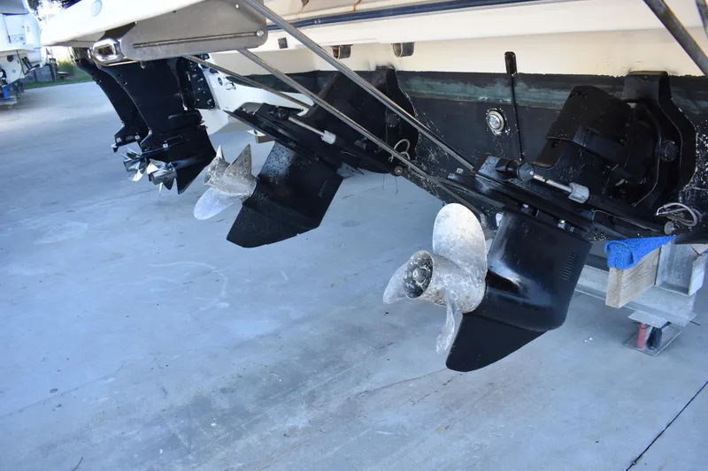 Slide: The Image of 2003 Bayliner 305 boat with dual propellers on a concrete surface. - 17