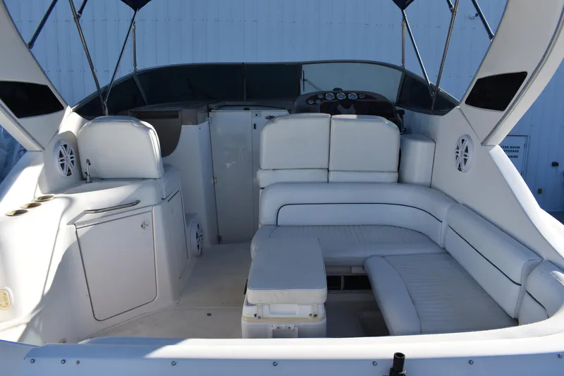 Slide: The Image of 2003 Bayliner 305 boat interior with white seating and helm station. - 19