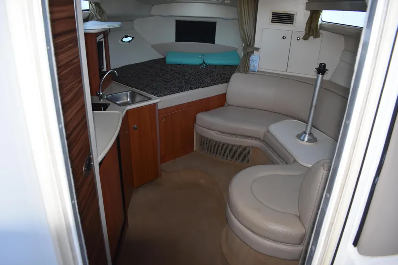 Slide: The Image of 2003 Bayliner 305 interior with kitchenette, seating area, and sleeping quarters. - 20